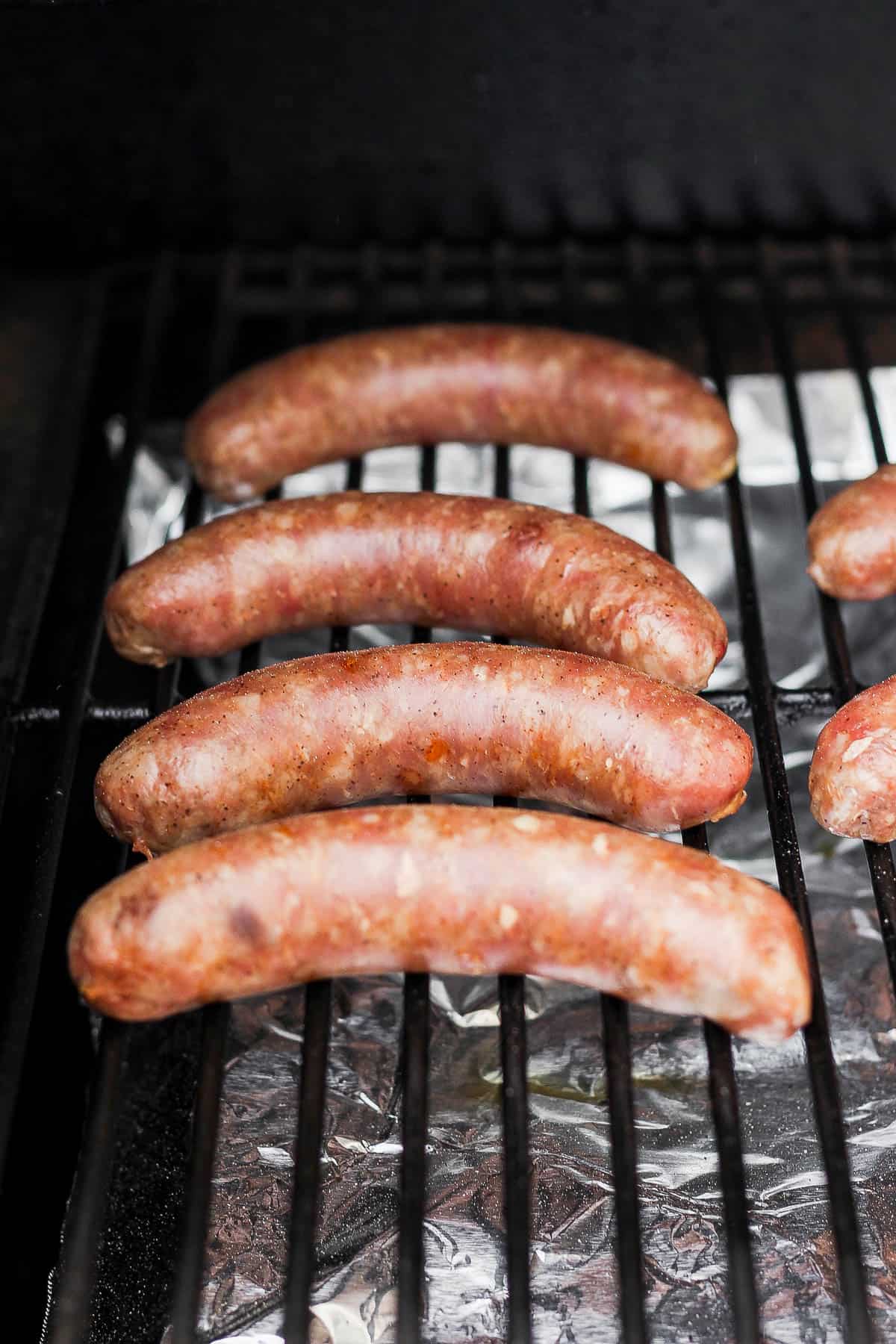 Brats on a smoker, fully cooked.