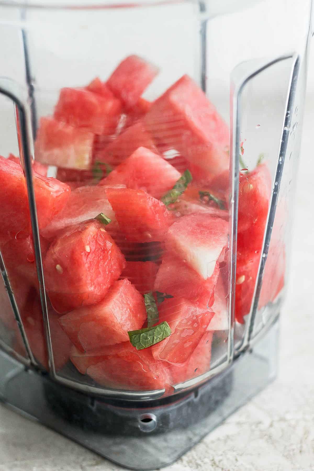 Ingredients for a watermelon cocktail in a blender.
