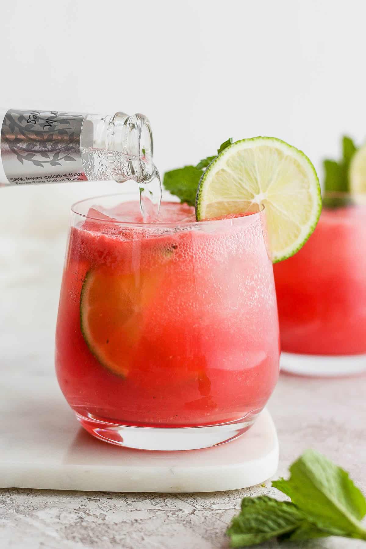 Club soda being added to an easy watermelon cocktail.