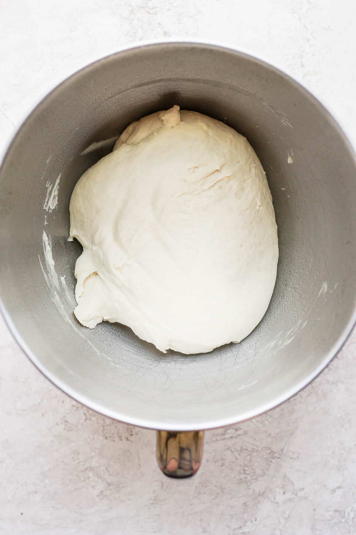 Combine pizza dough in a metal bowl.