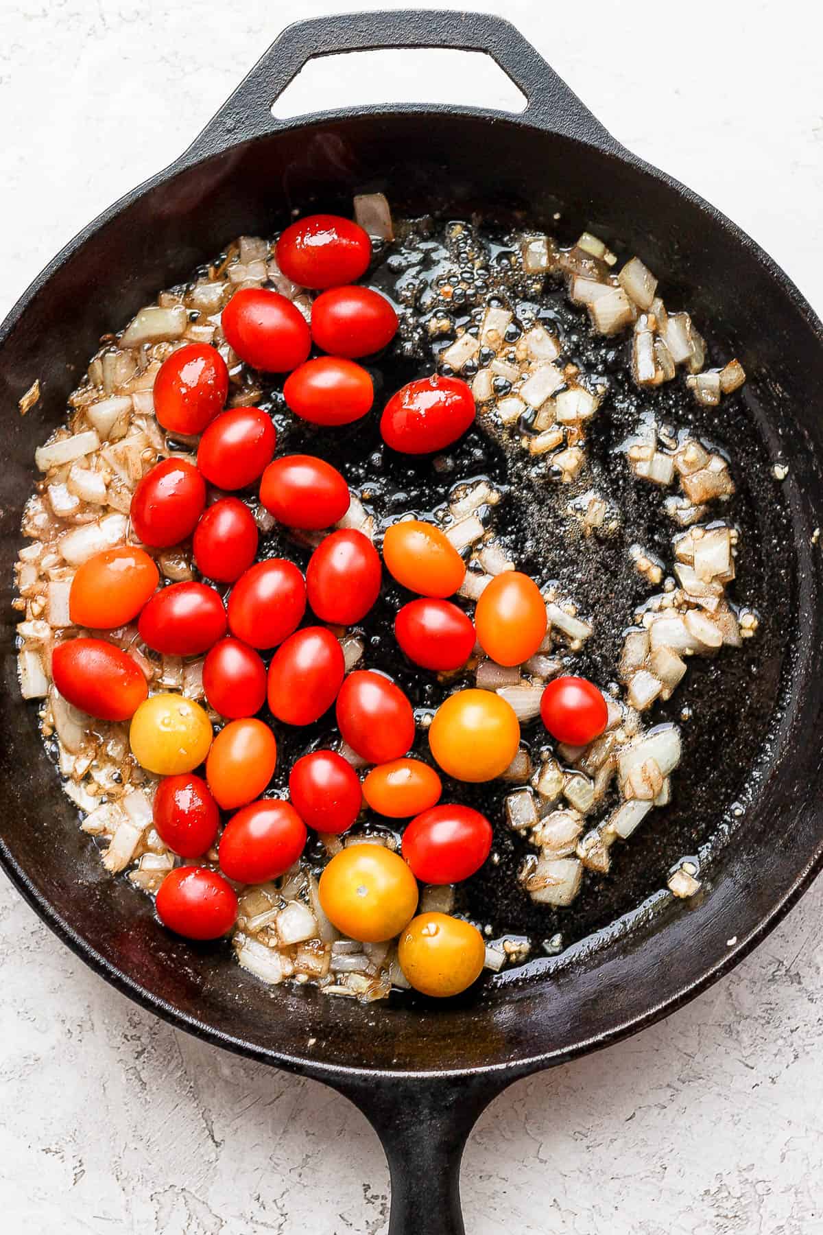 Cherry tomatoes added to the pan.
