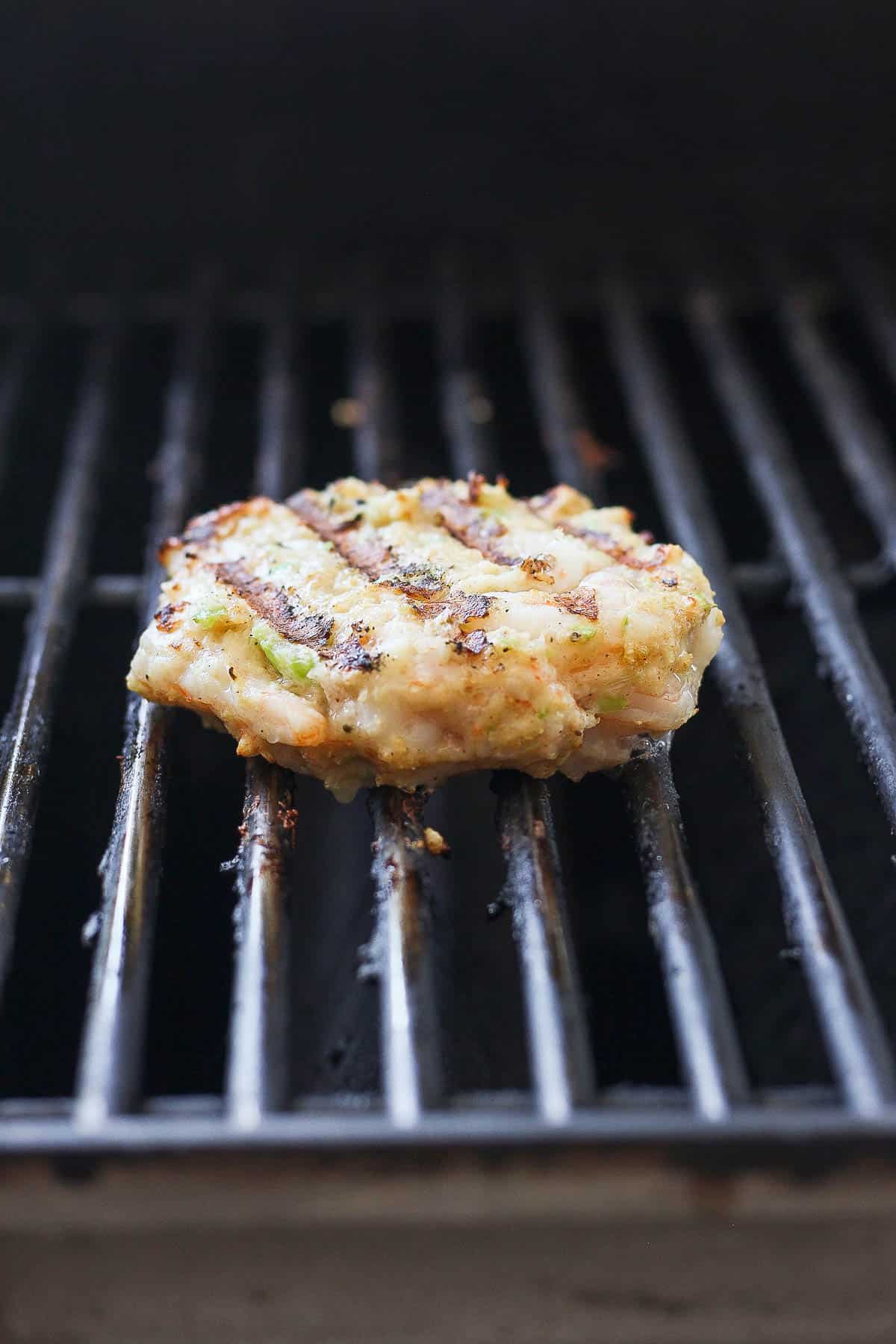A shrimp burger on the grill.