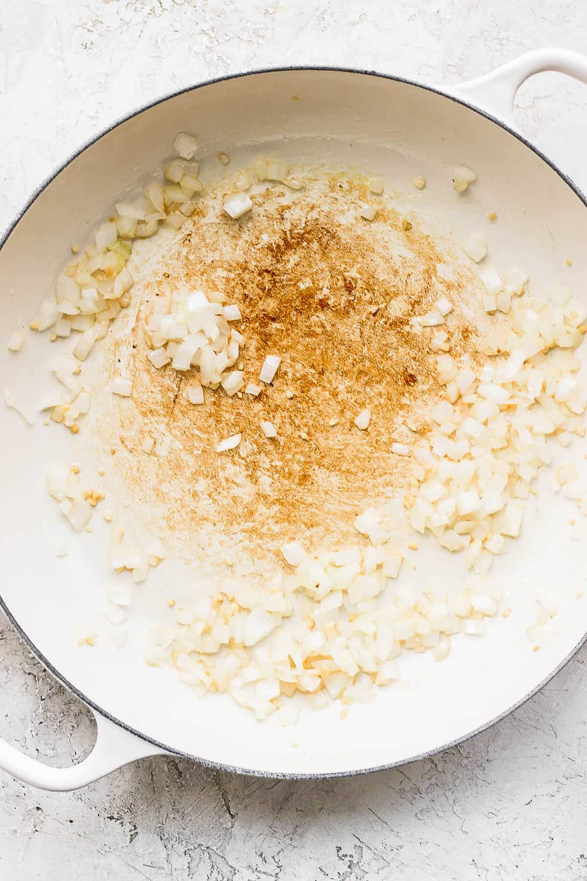 Garlic and onion sautéed in a skillet.