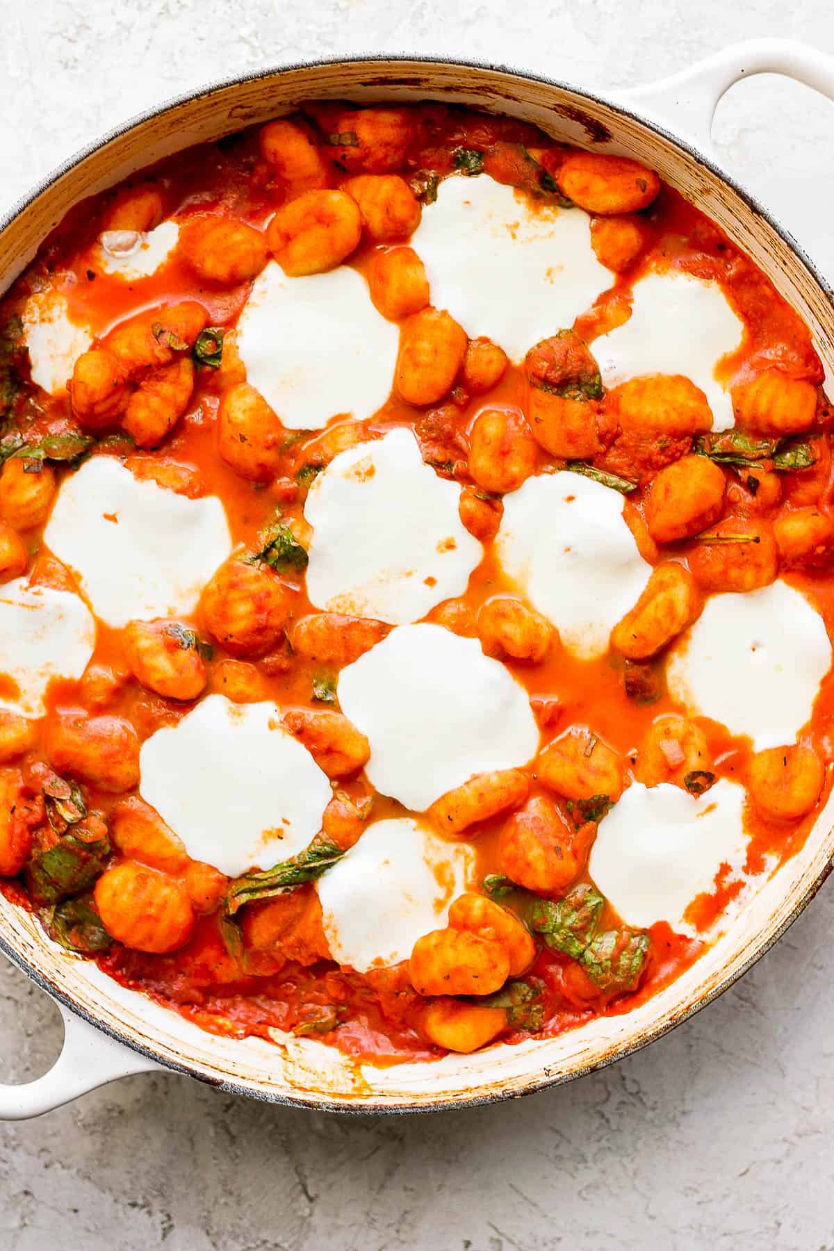 Baked gnocchi in a skillet after baking.