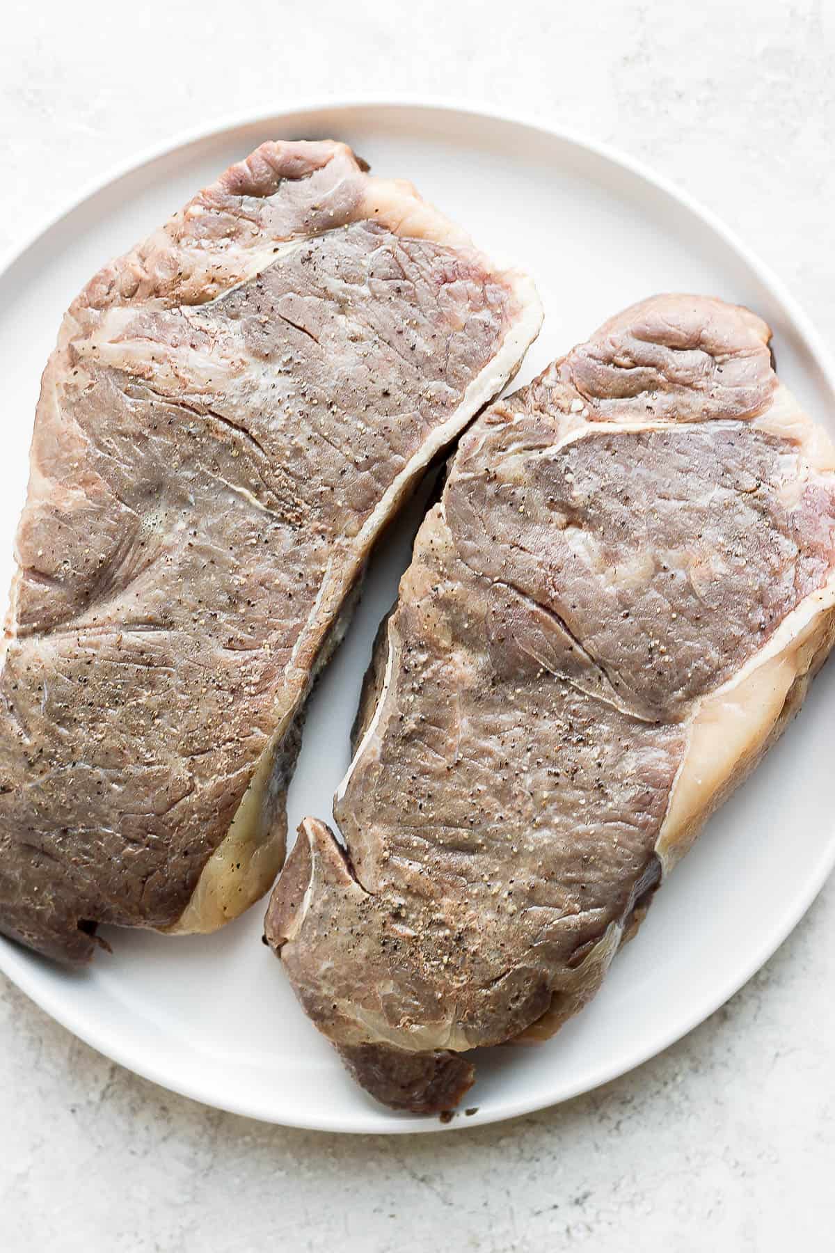 Steaks on a plate after being removed from the water.