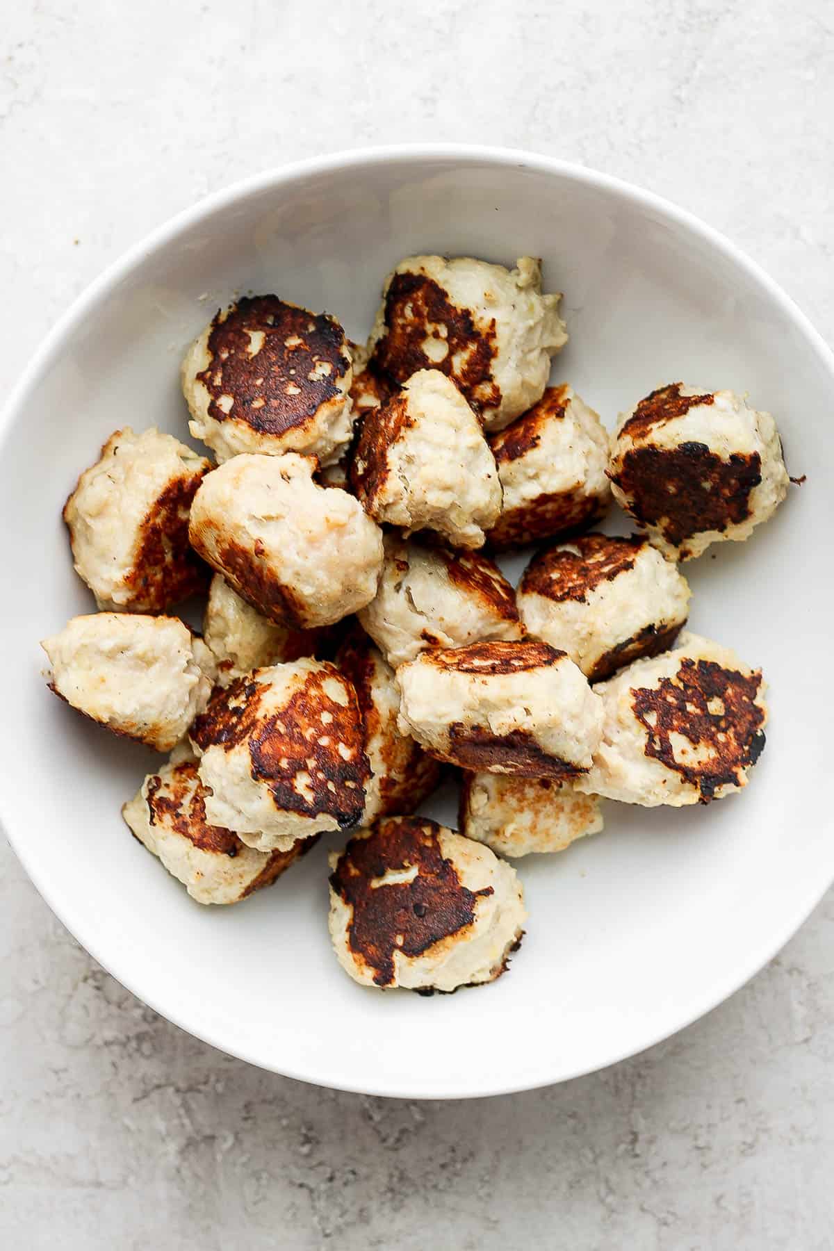 Seared chicken meatballs in a bowl.