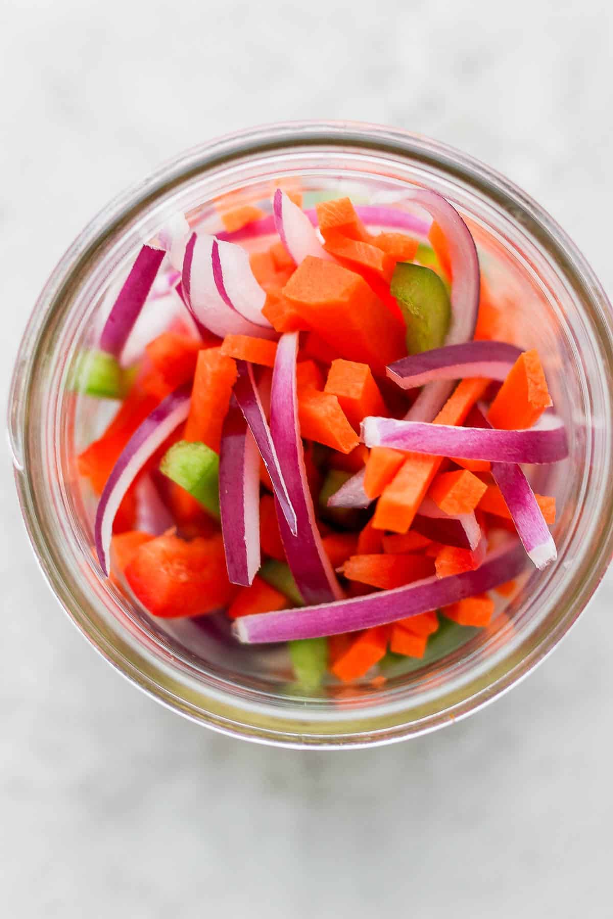 Thinly sliced vegetables in a mason jar.