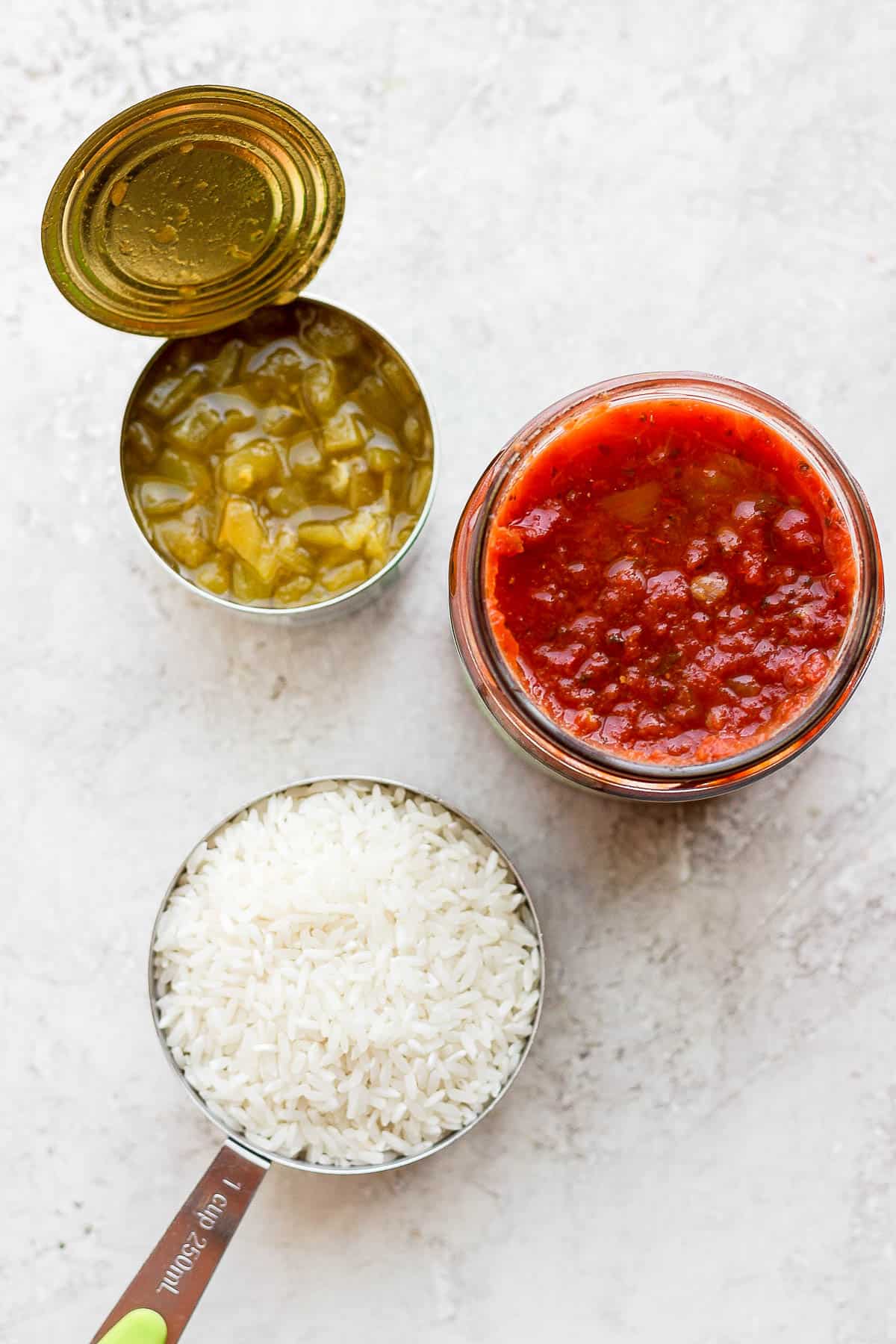 Canned green chilis, salsa, and uncooked long-grain white rice.