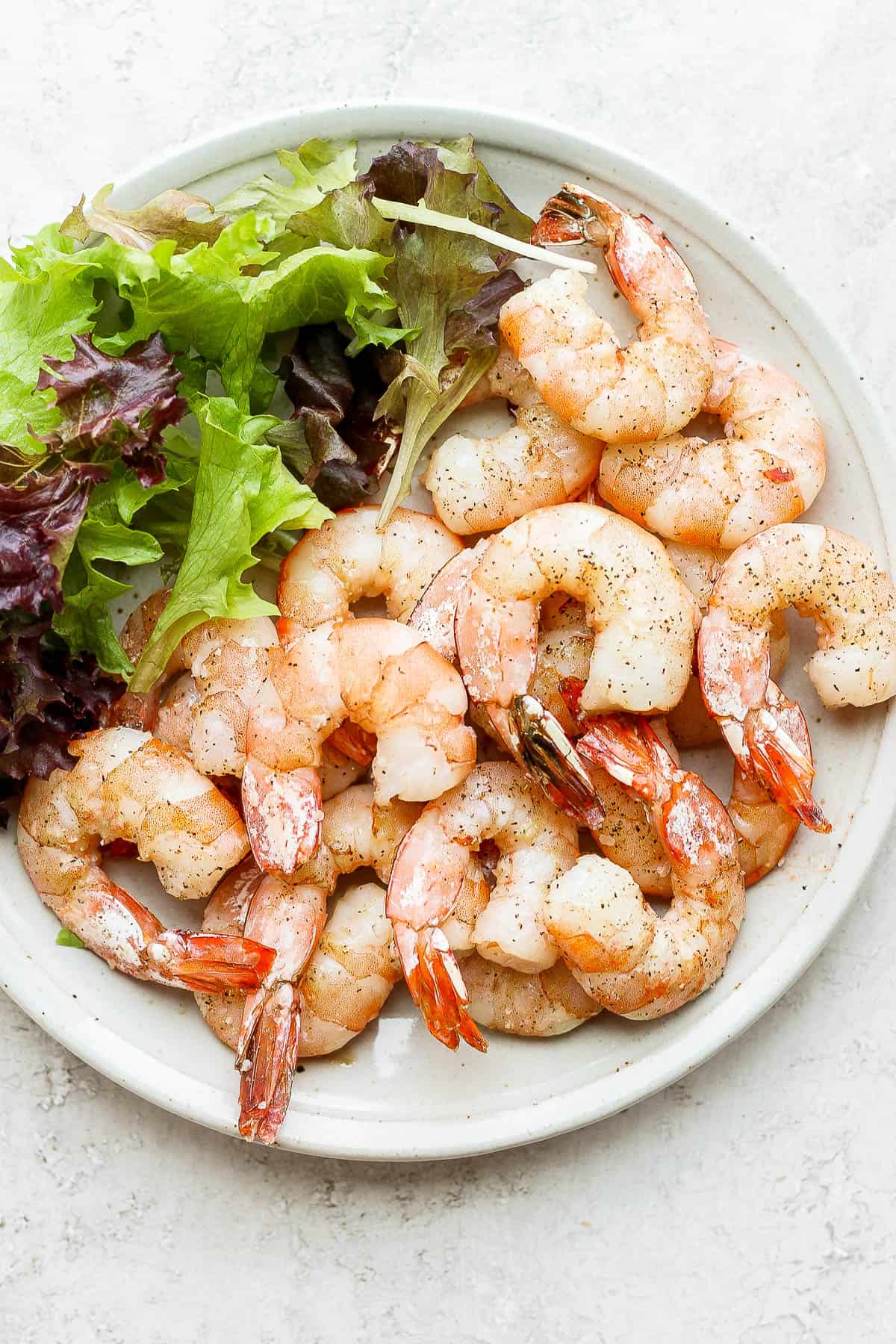 Smoked shrimp on a plate with a side salad.