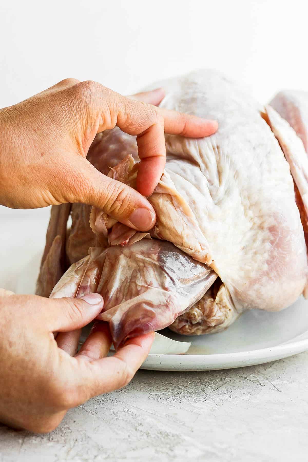 The bag of giblets being removed from the neck cavity.