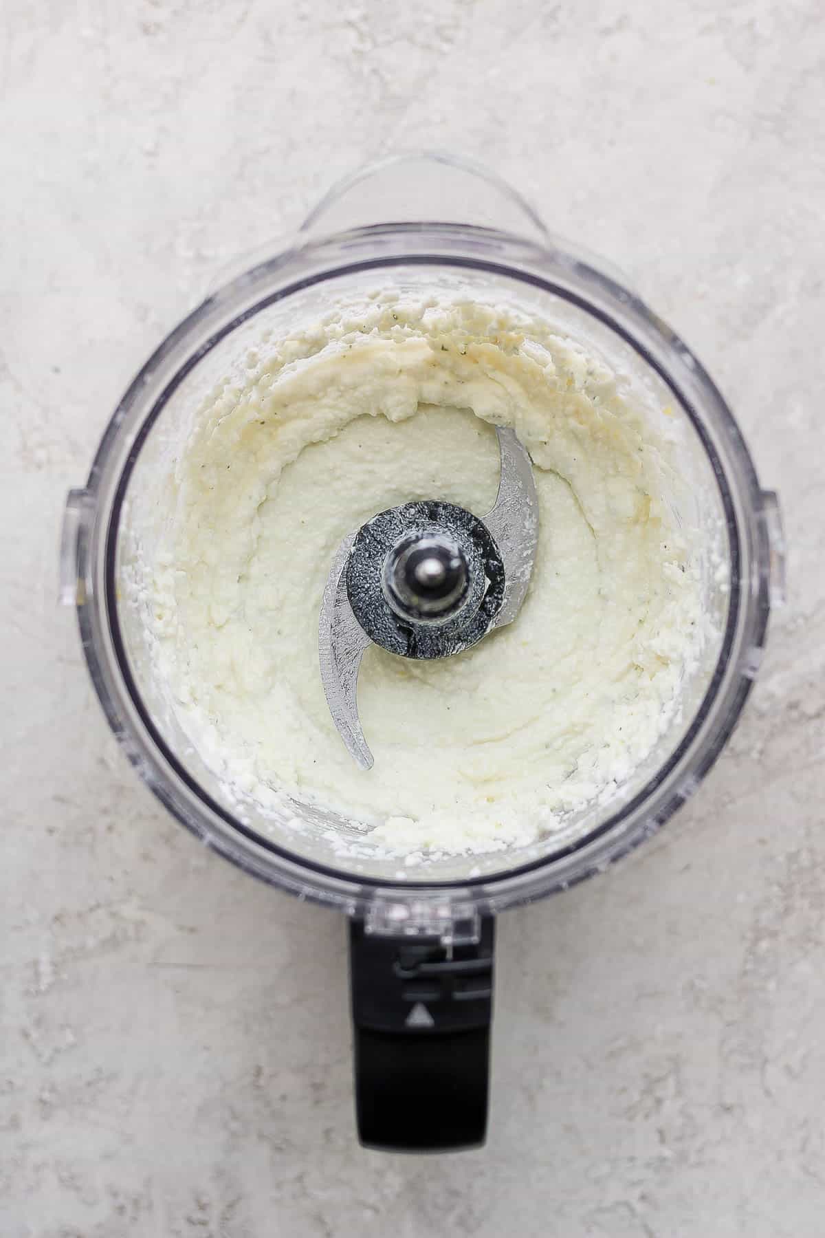 Whipped feta ingredients blended in a food processor. 