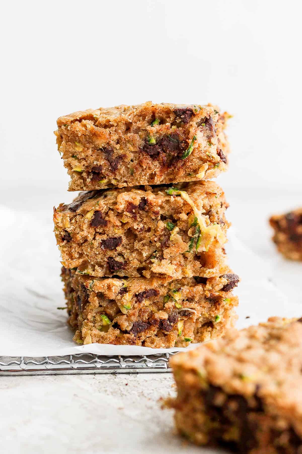Chocolate chip zucchini bars stacked on top of each other.