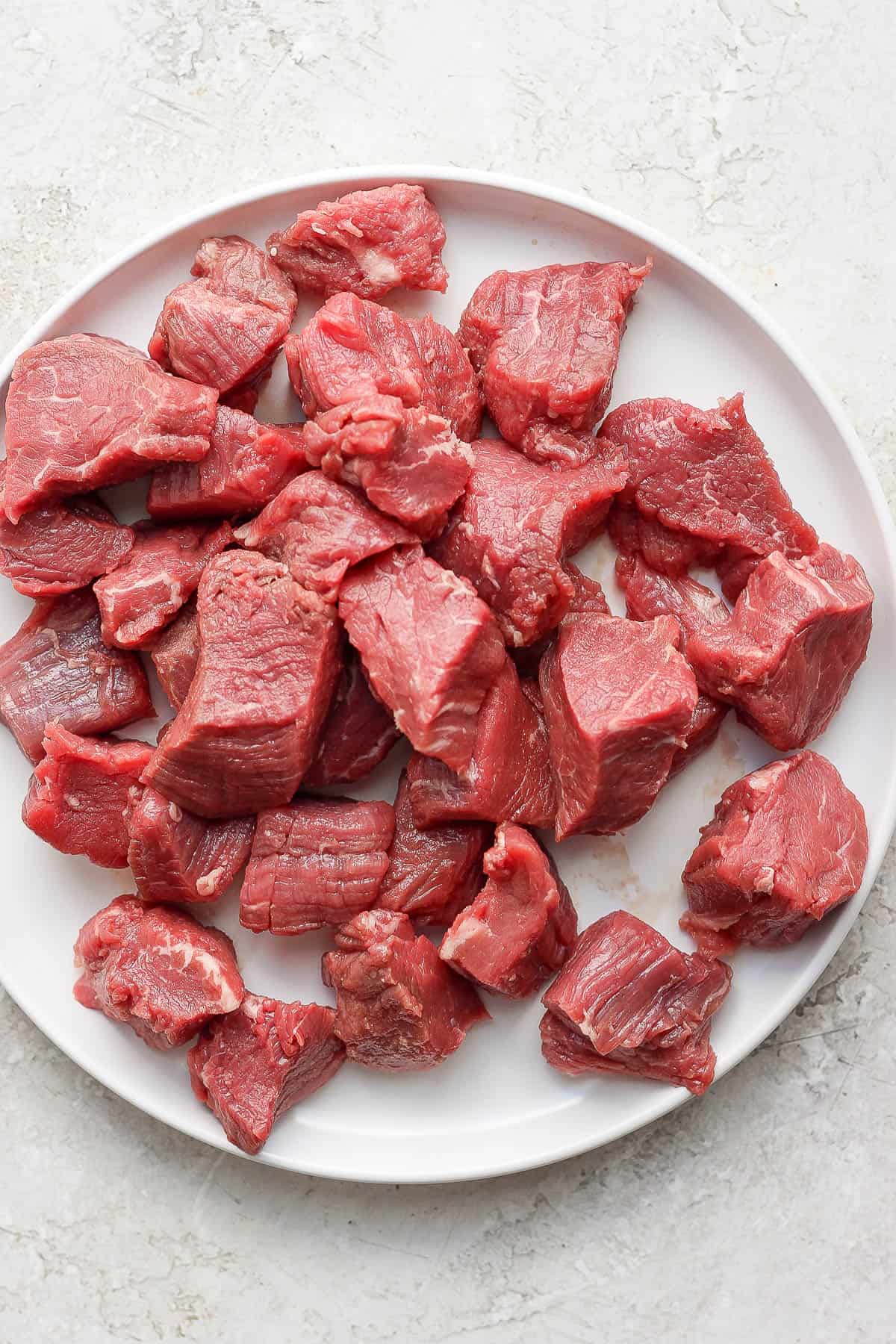 Cut-up beef tenderloin steak tips on a plate.