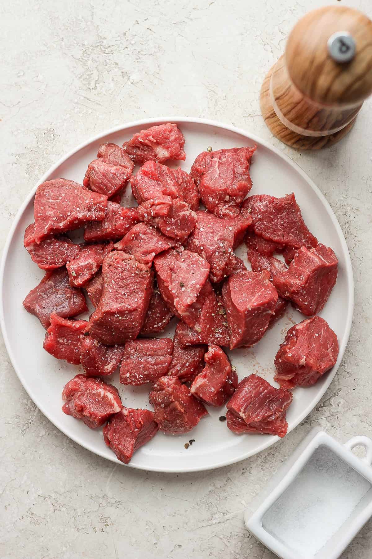 Steak tips seasoned with salt and pepper.