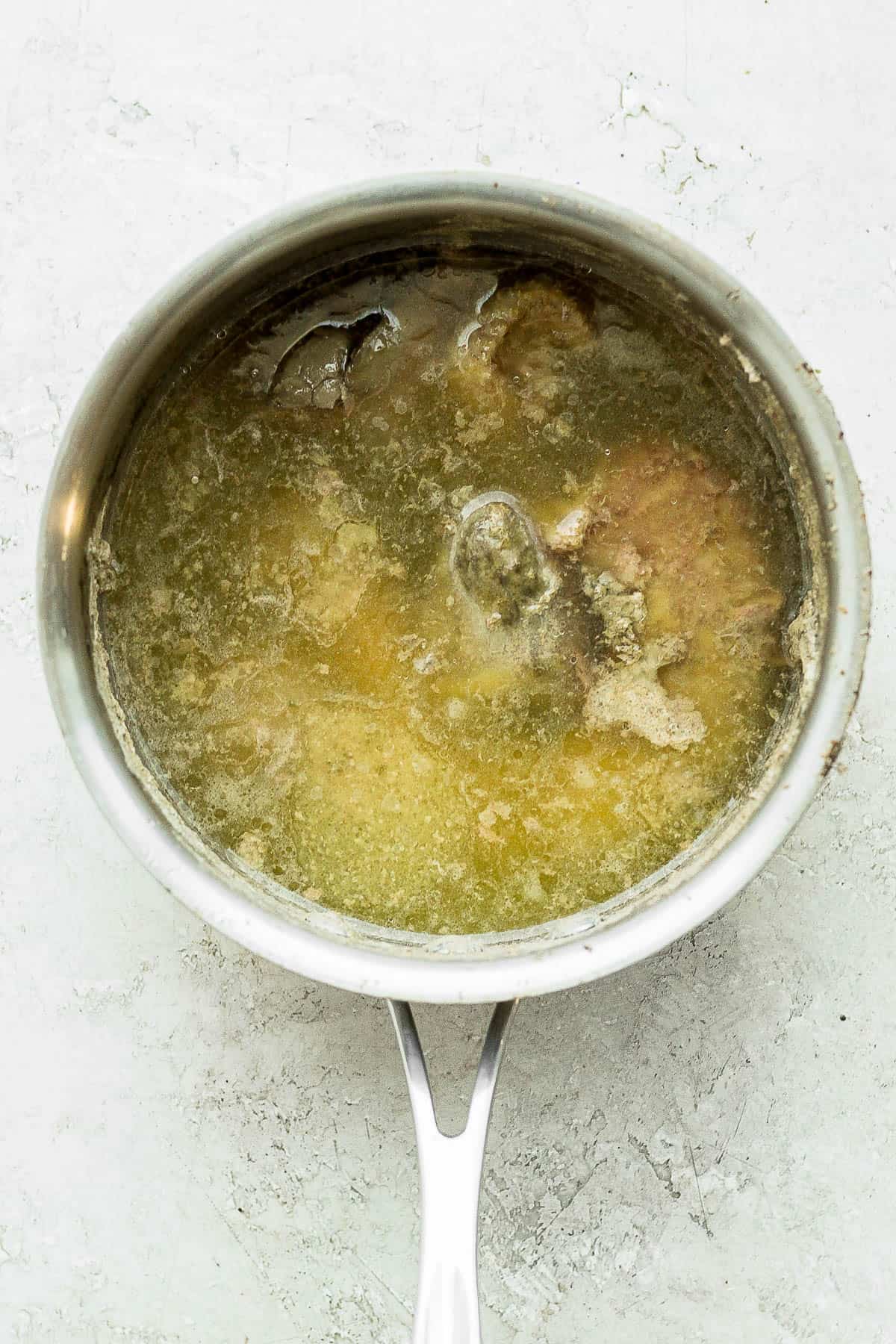 Fully cooked turkey giblets in a saucepan with water.