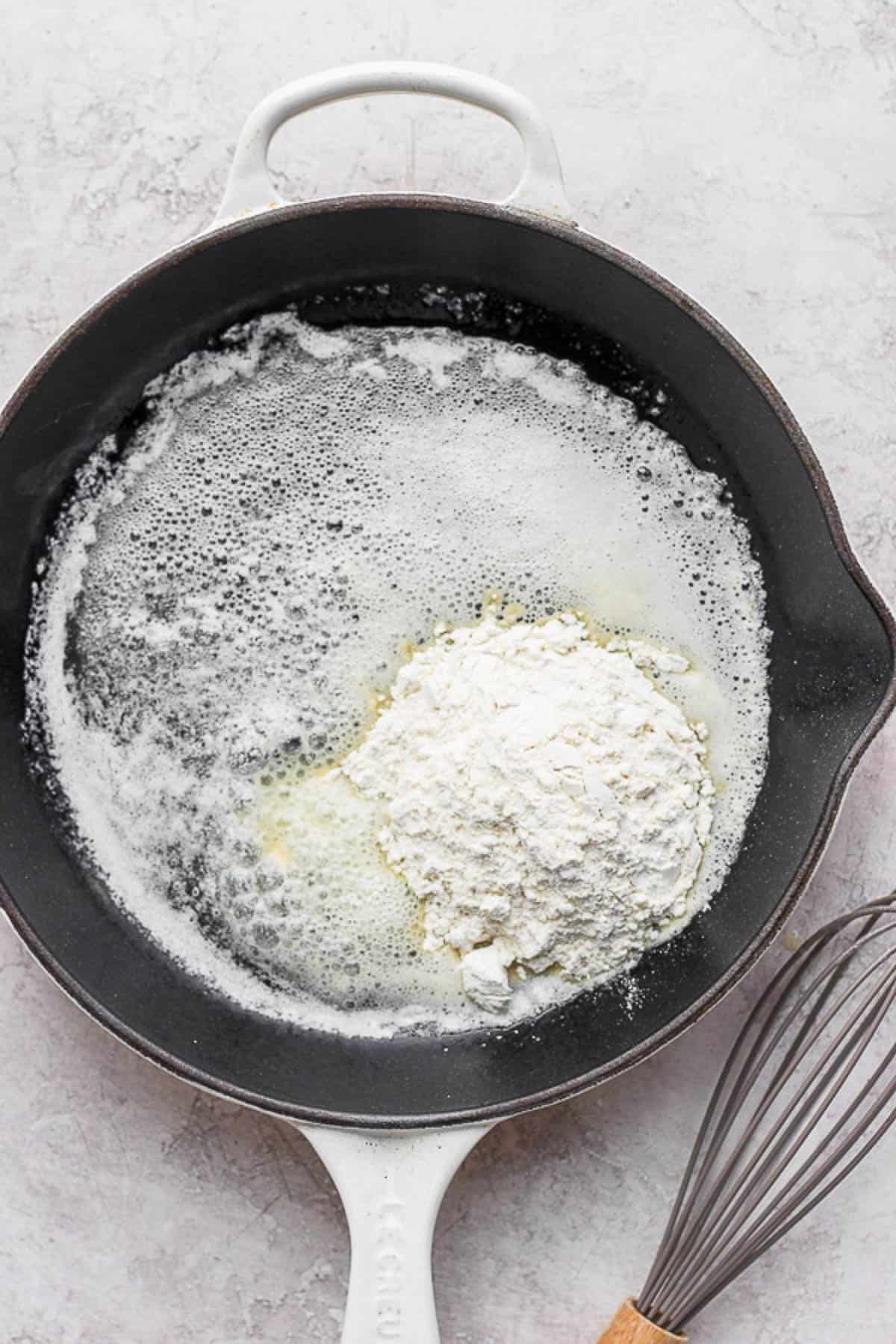Flour added to melted butter in a skillet.