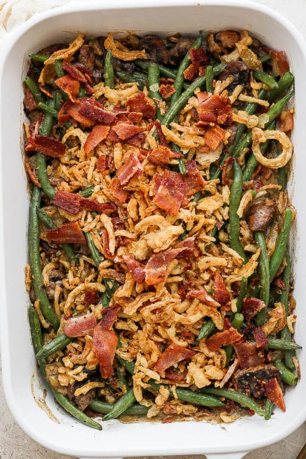 Green bean casserole with bacon in a casserole pan.