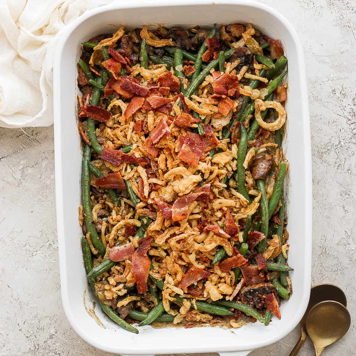 Green bean casserole with bacon in a casserole pan.