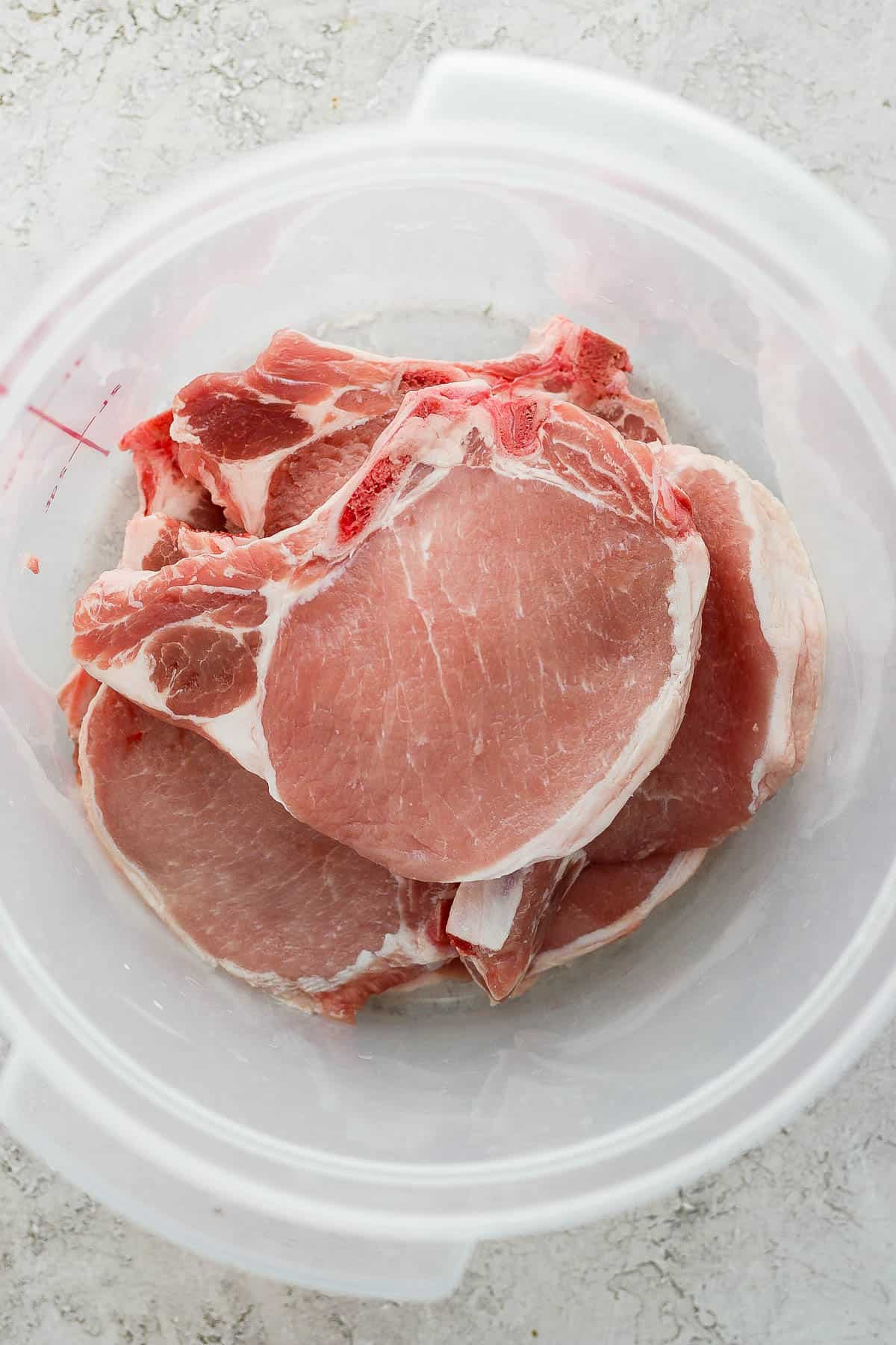Pork chops in a food safe container.