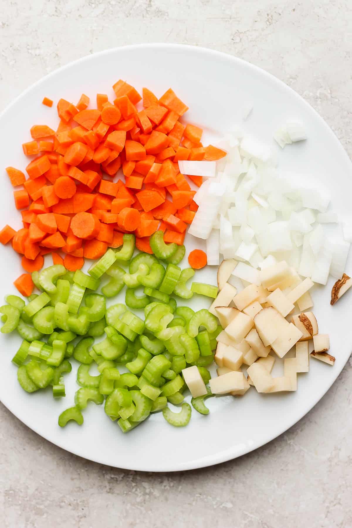 Chopped vegetables on a large plate.