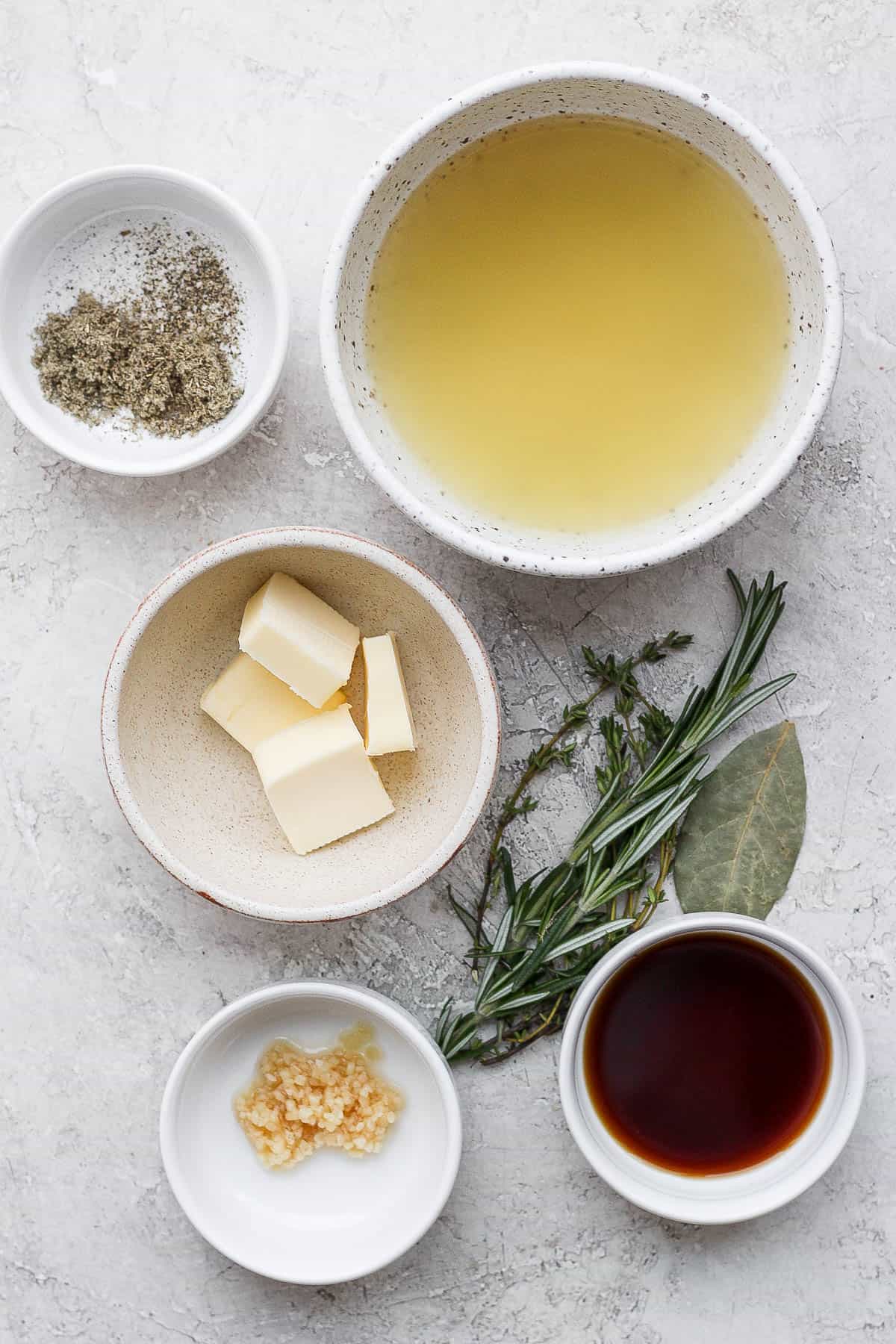 Ingredients for a turkey injection in separate bowls.