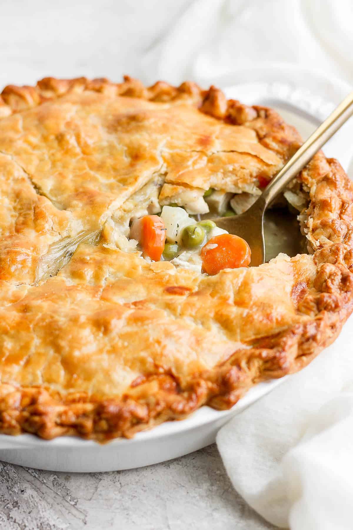 Chicken pot pie with a spoon in it.