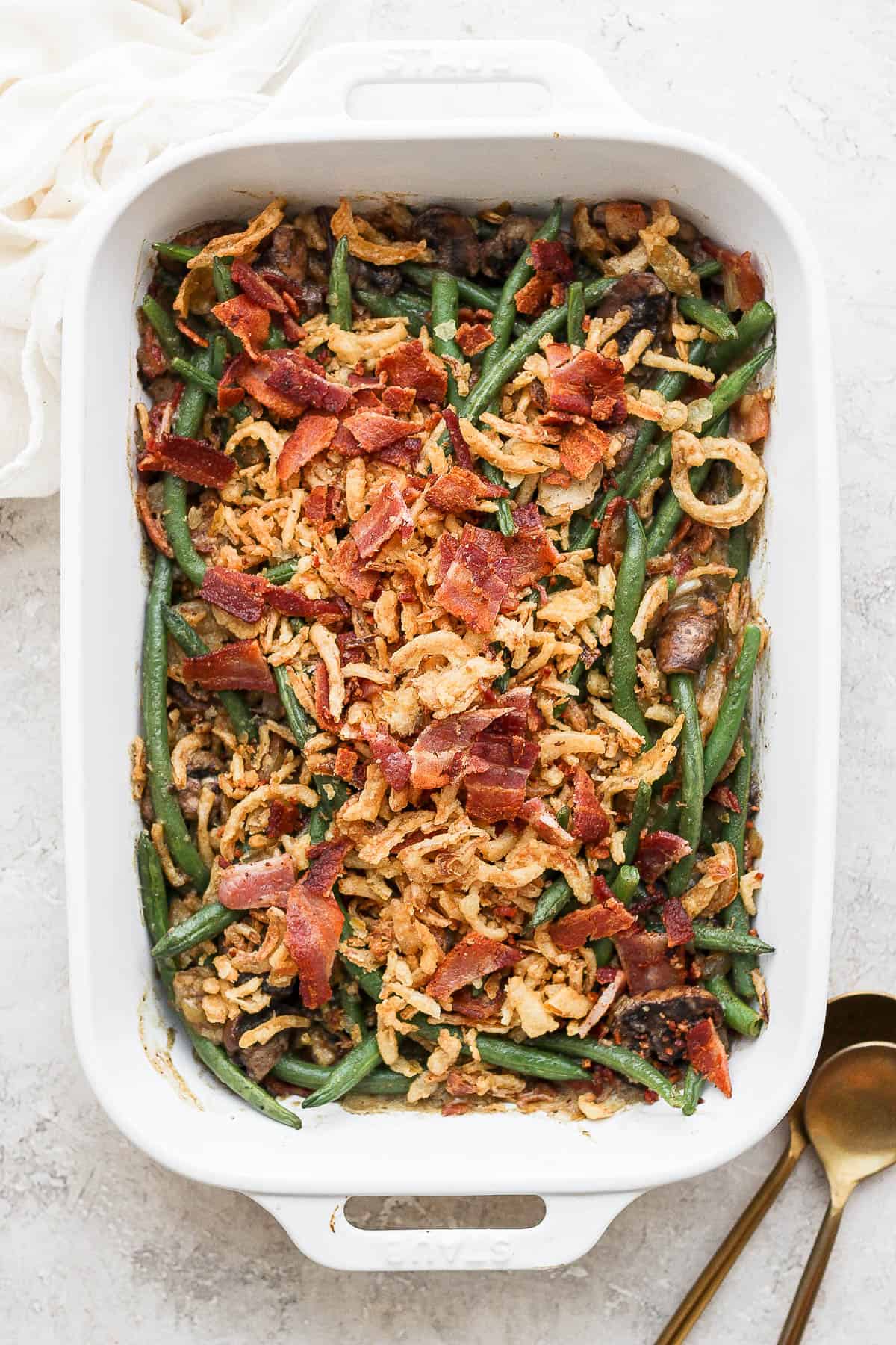 Green bean casserole with bacon in a casserole dish.