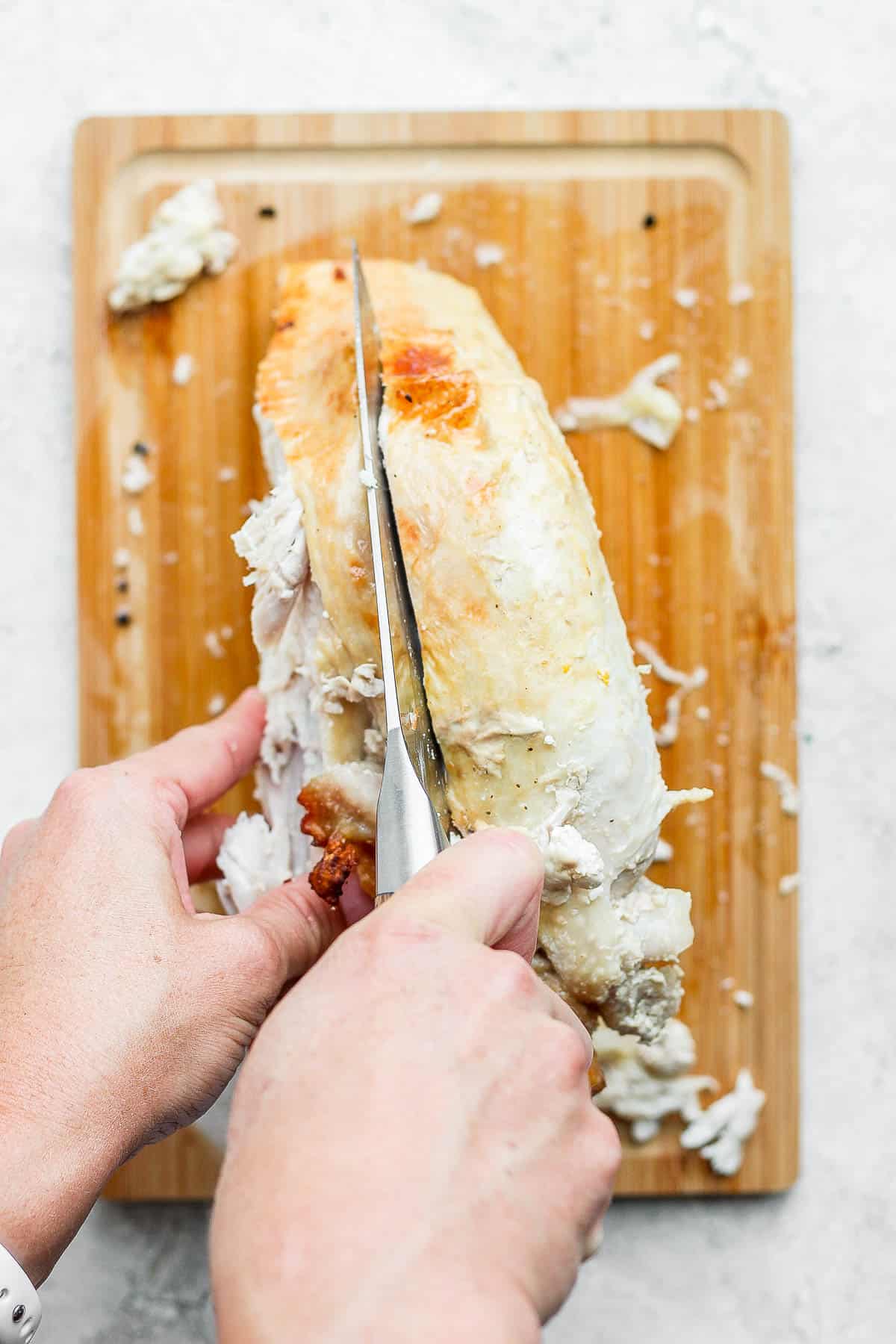 Knife inserted on the other side of the breastbone to remove that turkey breast.