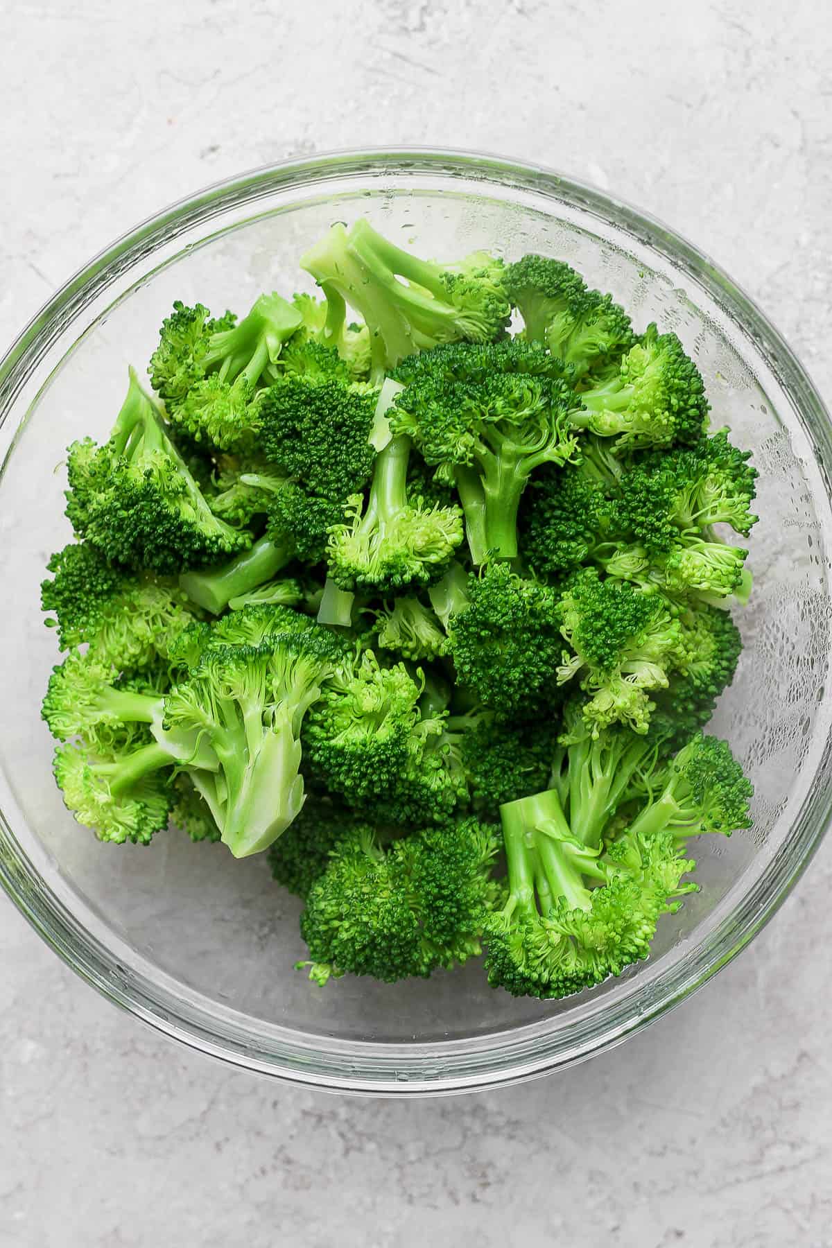 Steamed broccoli in a glass bowl.