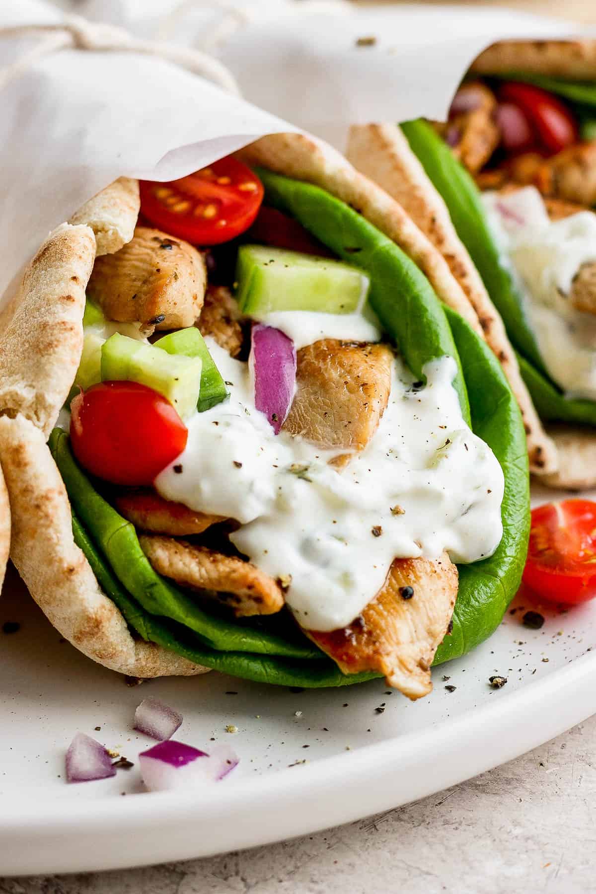 Close-up shot of a chicken gyro on a plate.