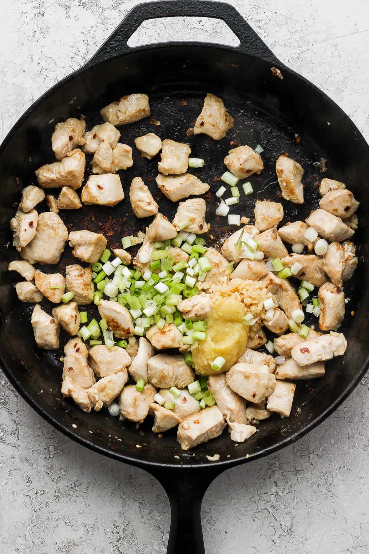 Green onion, garlic, and ginger added to the pan.