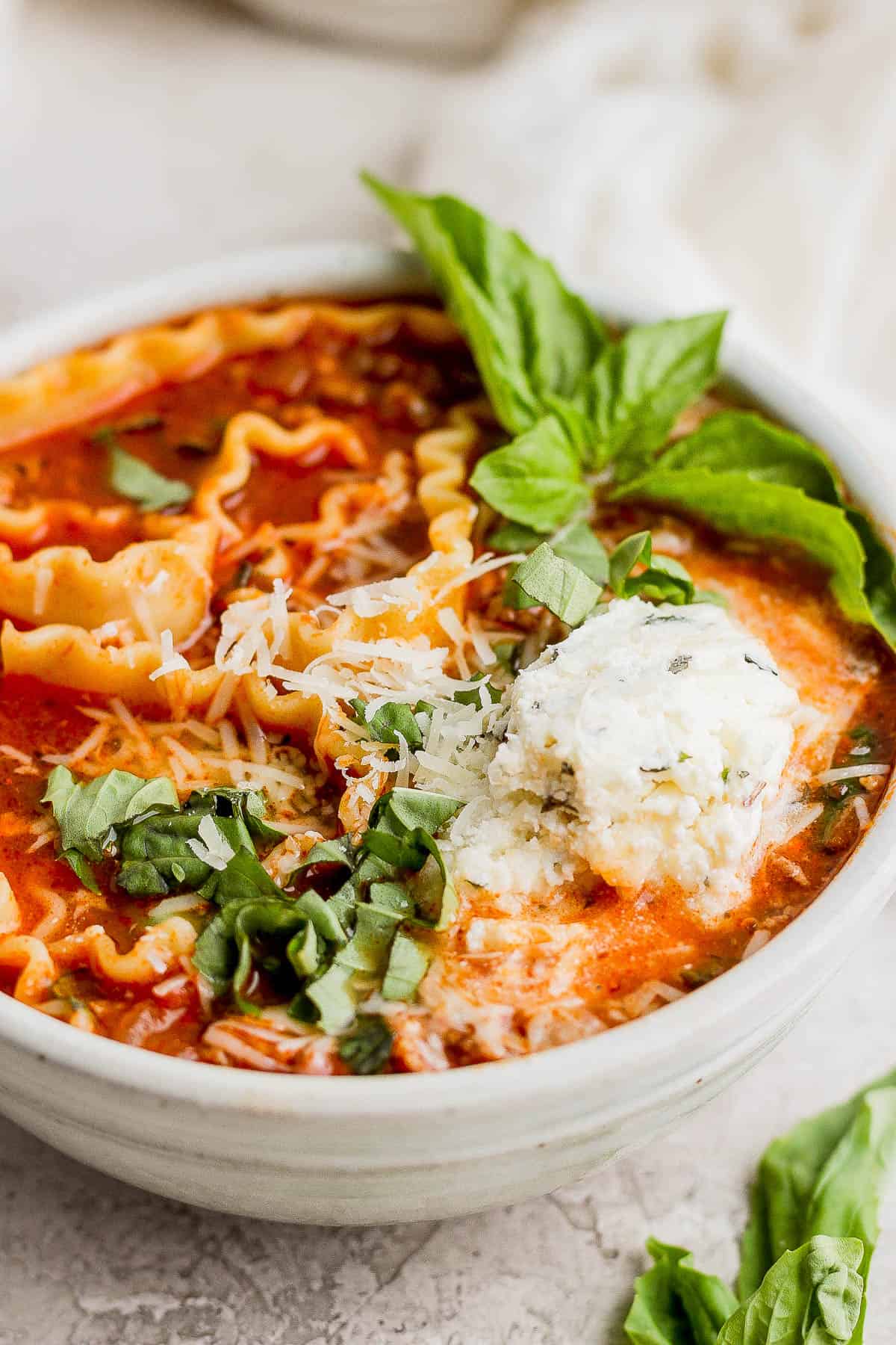 Lasagna soup in a white bowl.