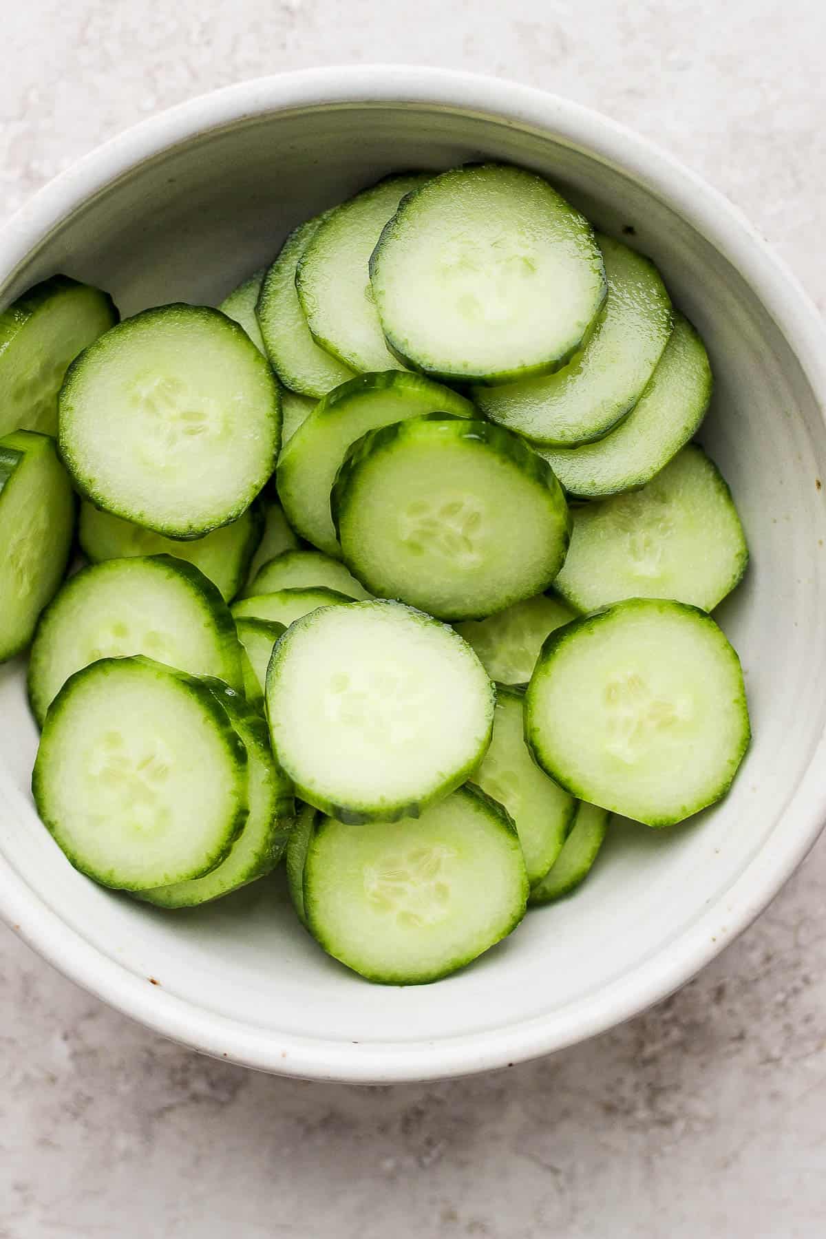 Thinly sliced cucumber in a bowl.