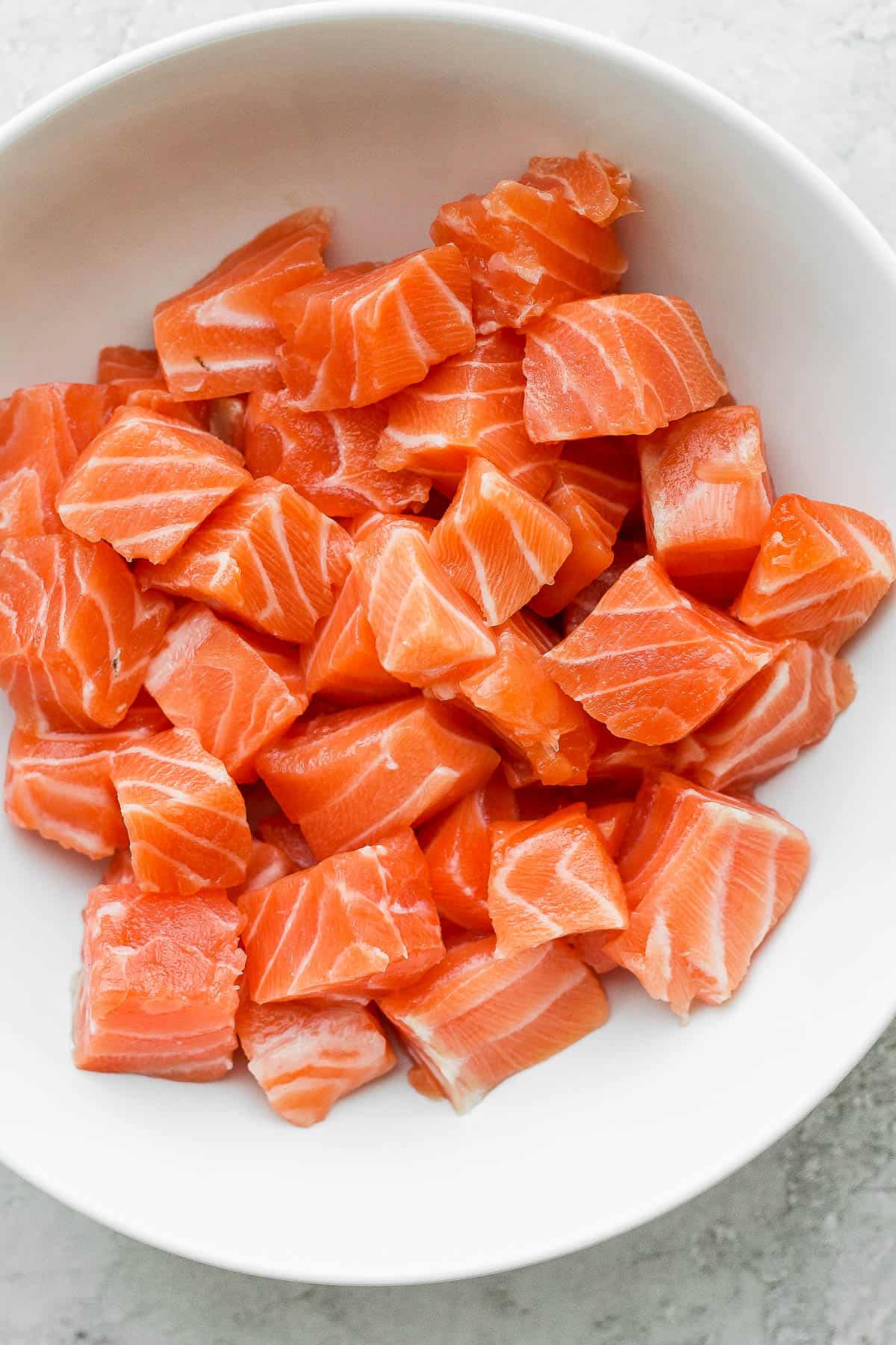 One-inch cubes of salmon in a bowl.
