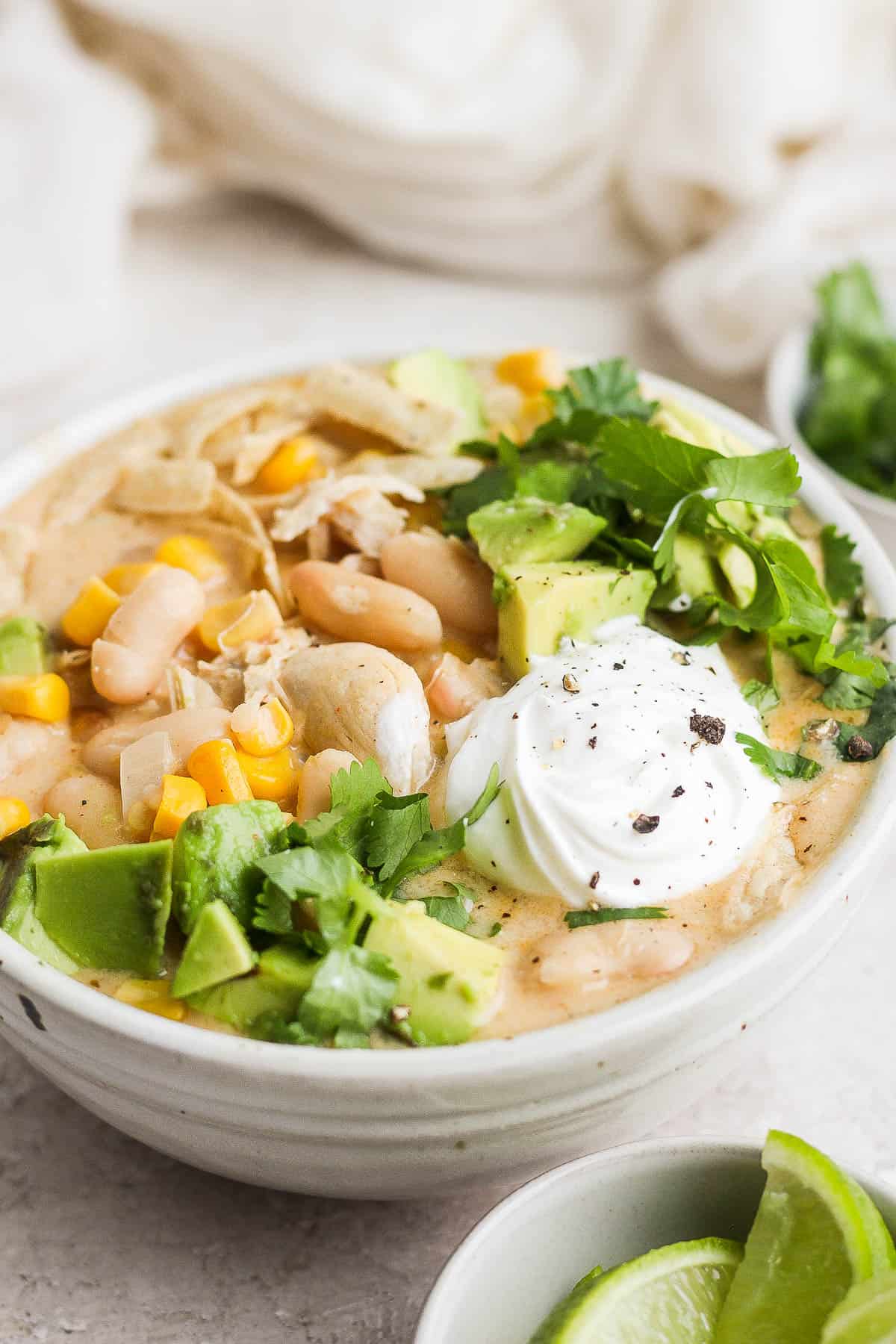 White chicken chili in a bowl with toppings.