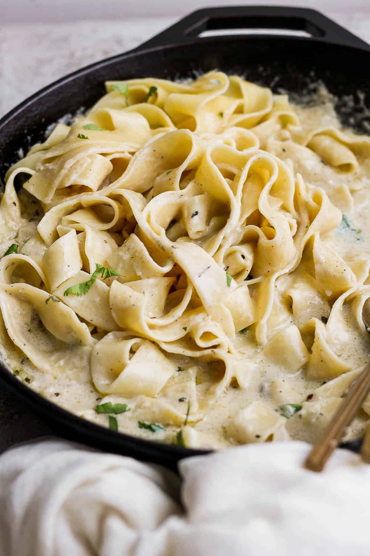 A homemade alfredo pasta in a skillet.