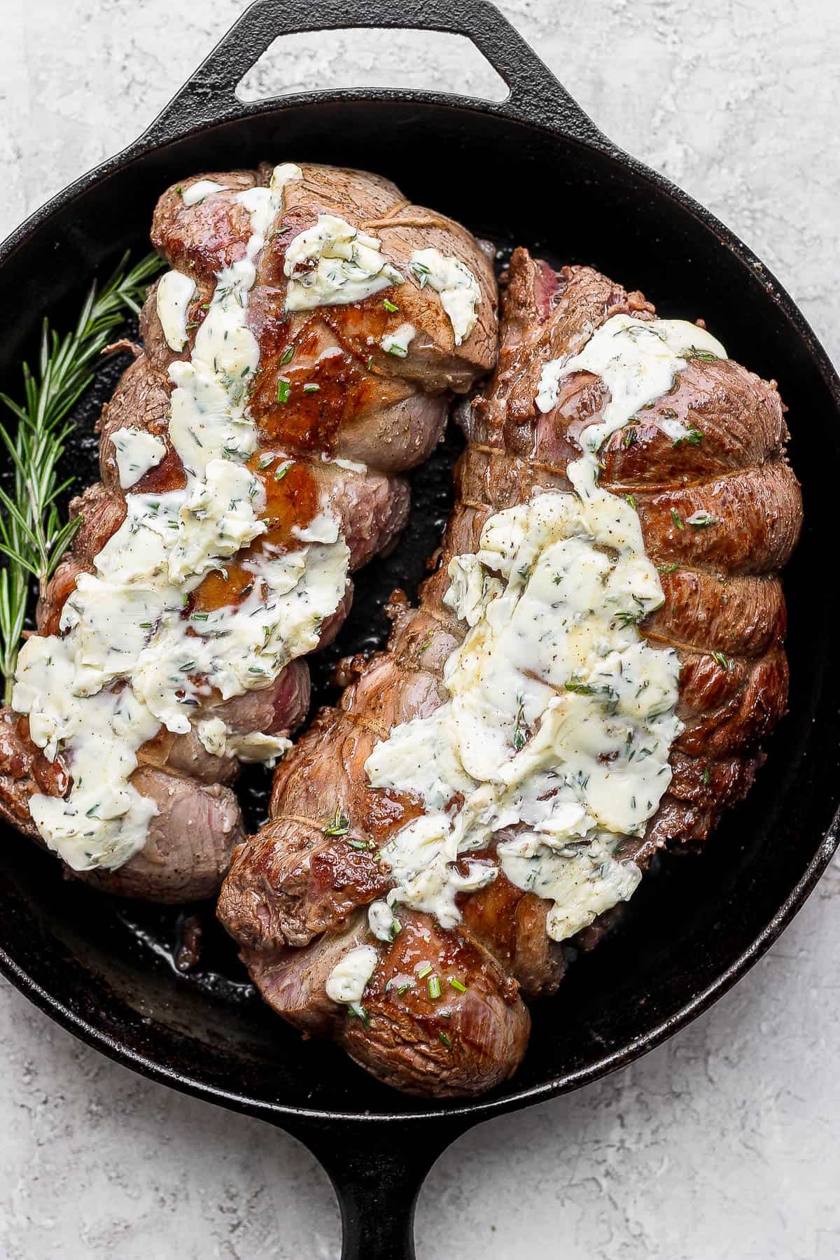 Beef tenderloin slathered in herb butter.