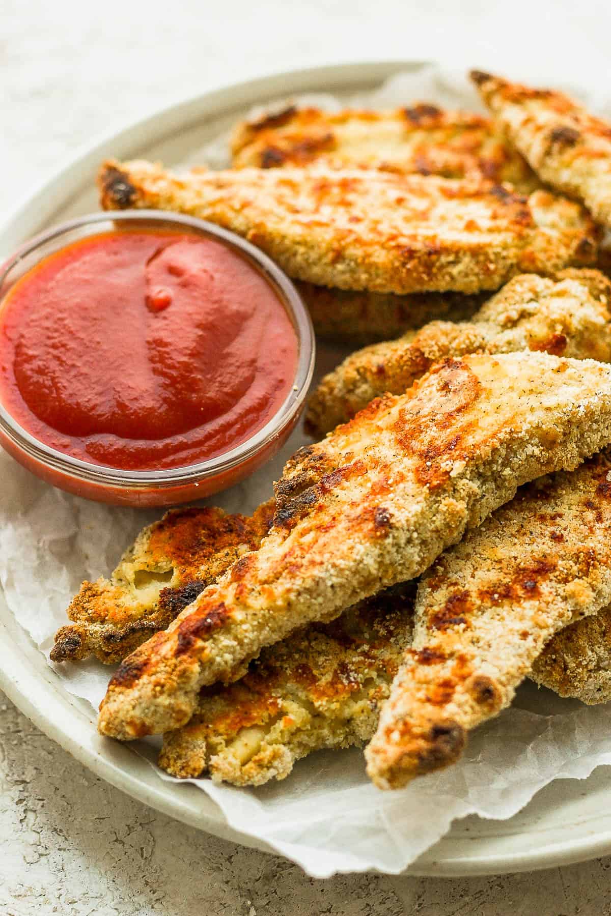 Chicken tenders with ketchup on the side.