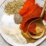 Plate of fajita seasoning with a golden spoon sticking out.