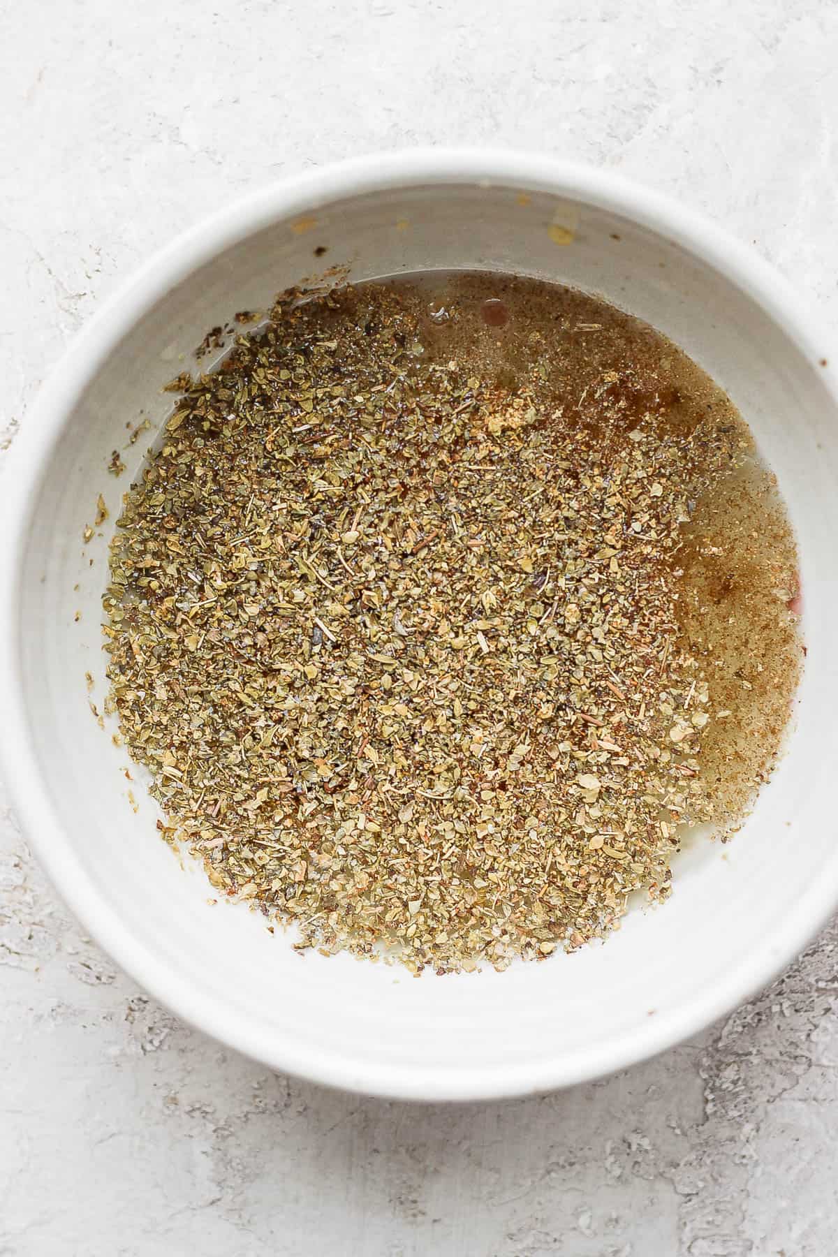 All of the marinade ingredients in a small mixing bowl.