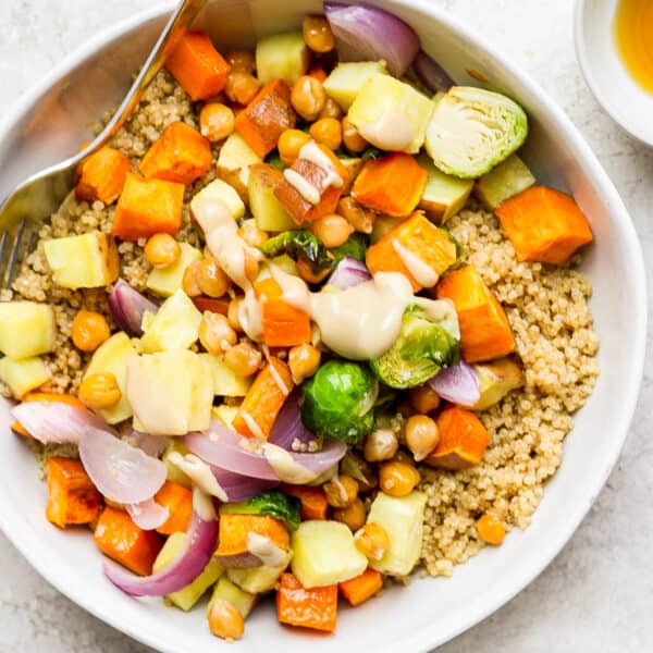 Quinoa bowl with yams, sweet potatoes, brussels sprouts and peanut dressing.