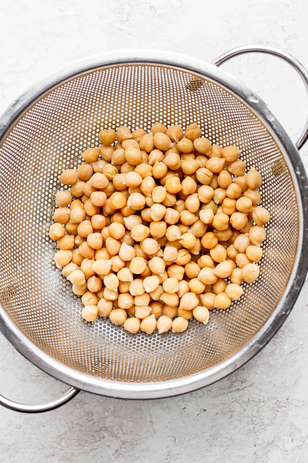 Chickpeas in a mesh sieve.