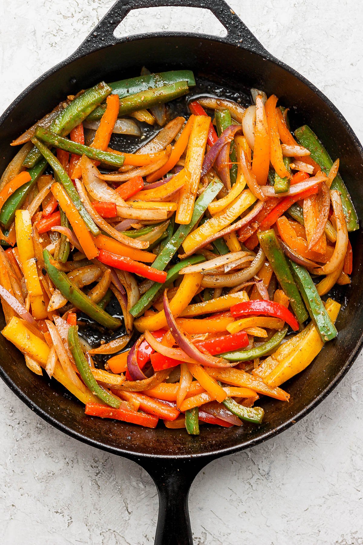 Fajita veggies in a cast iron skillet.