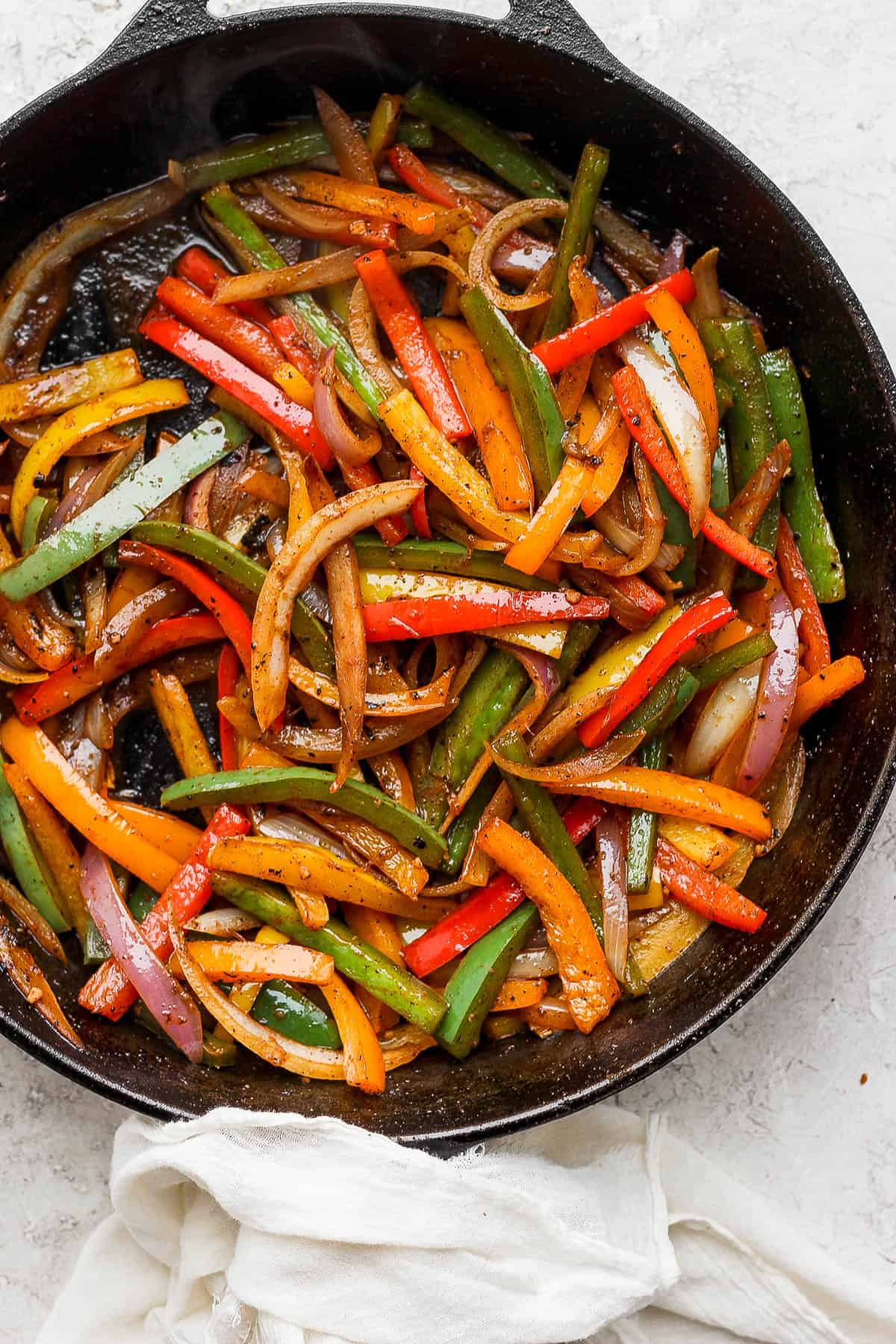 steak and chicken fajitas close up in cast iron fajita skillet