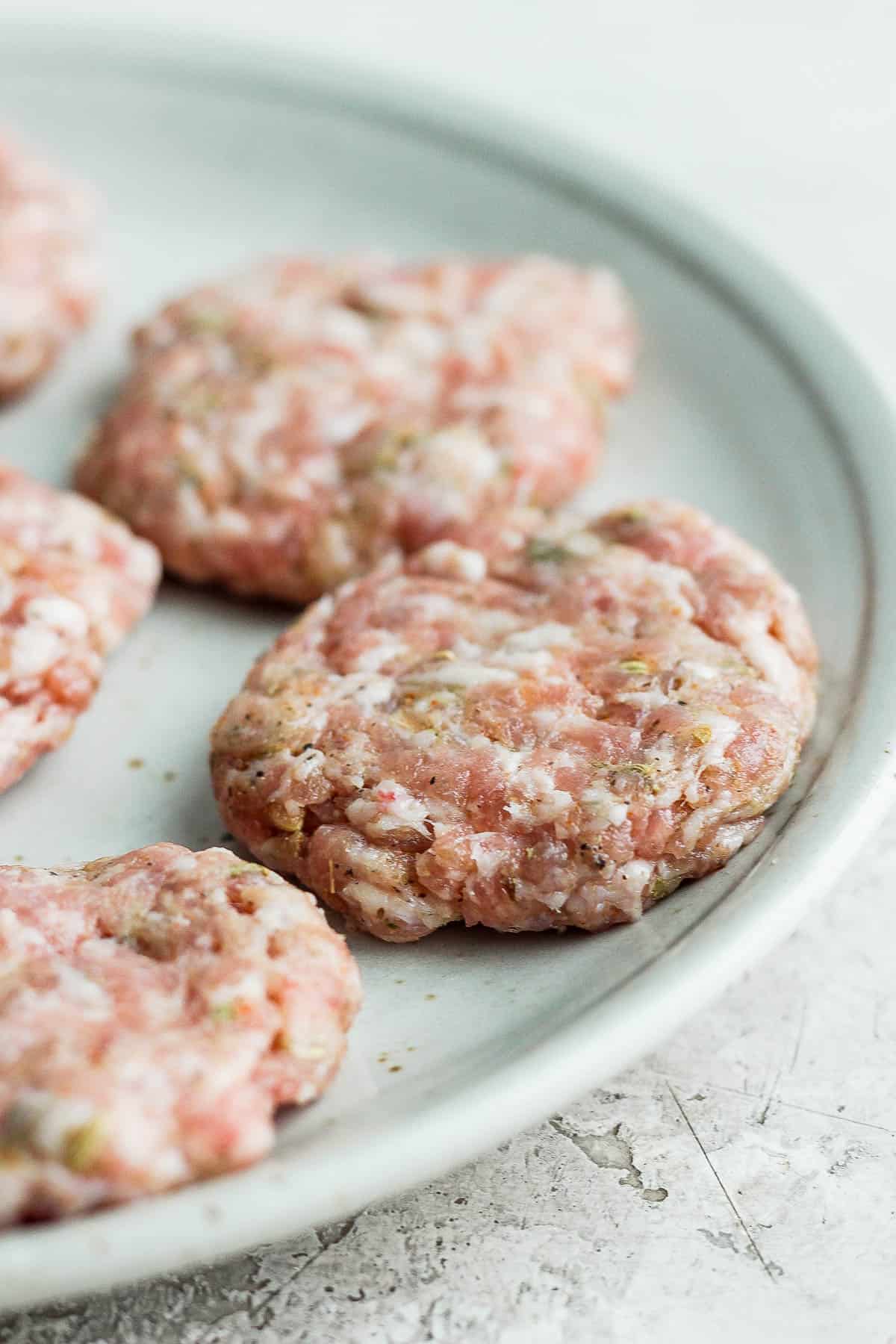 Sausage patties on a white plate.