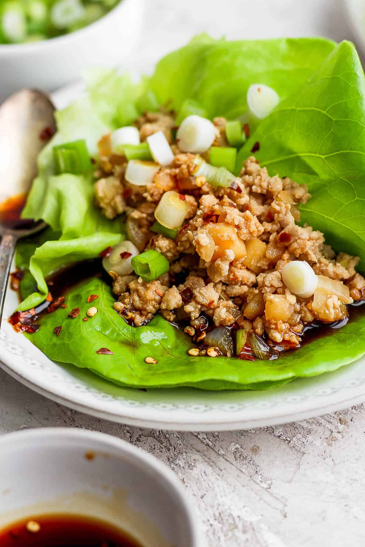 A chicken lettuce wrap on a plate.