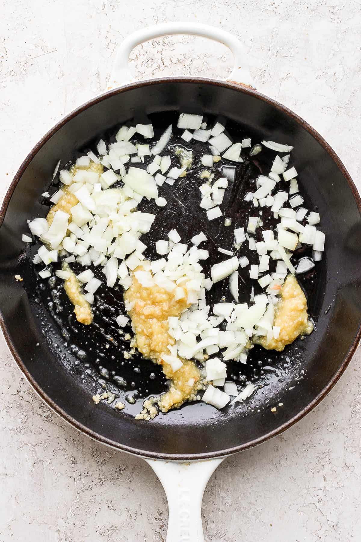 Chopped yellow onion added to the pan.