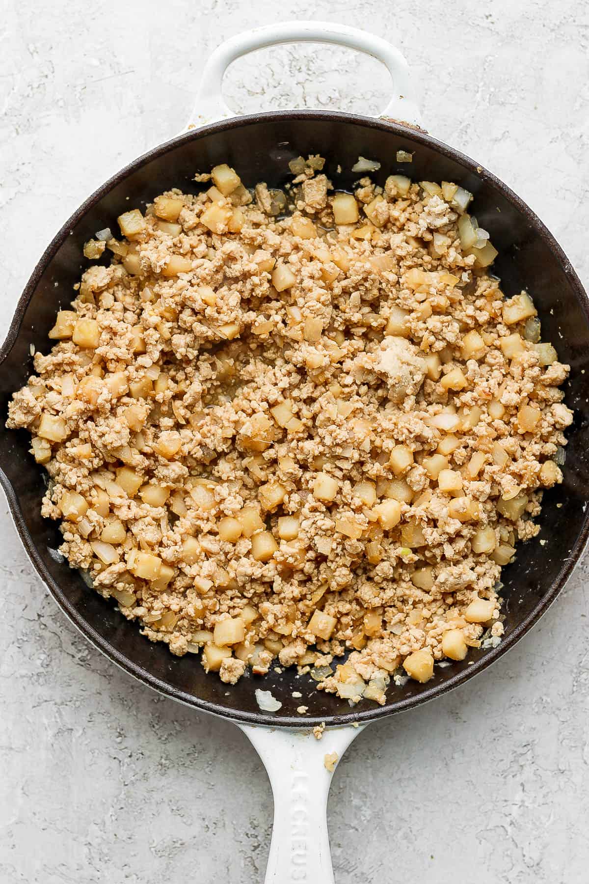 The finished chicken mixture in a cast iron skillet.