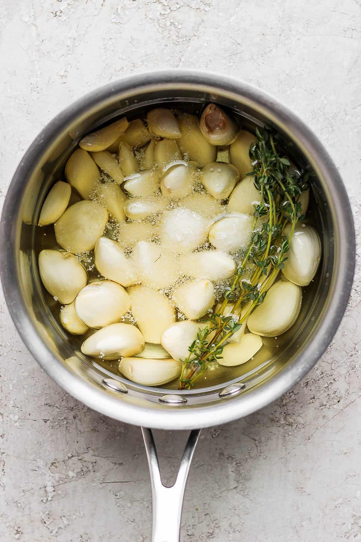 Salt and fresh thyme added to the saucepan.