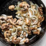 sautéed mushrooms and onions in a cast iron skillet.